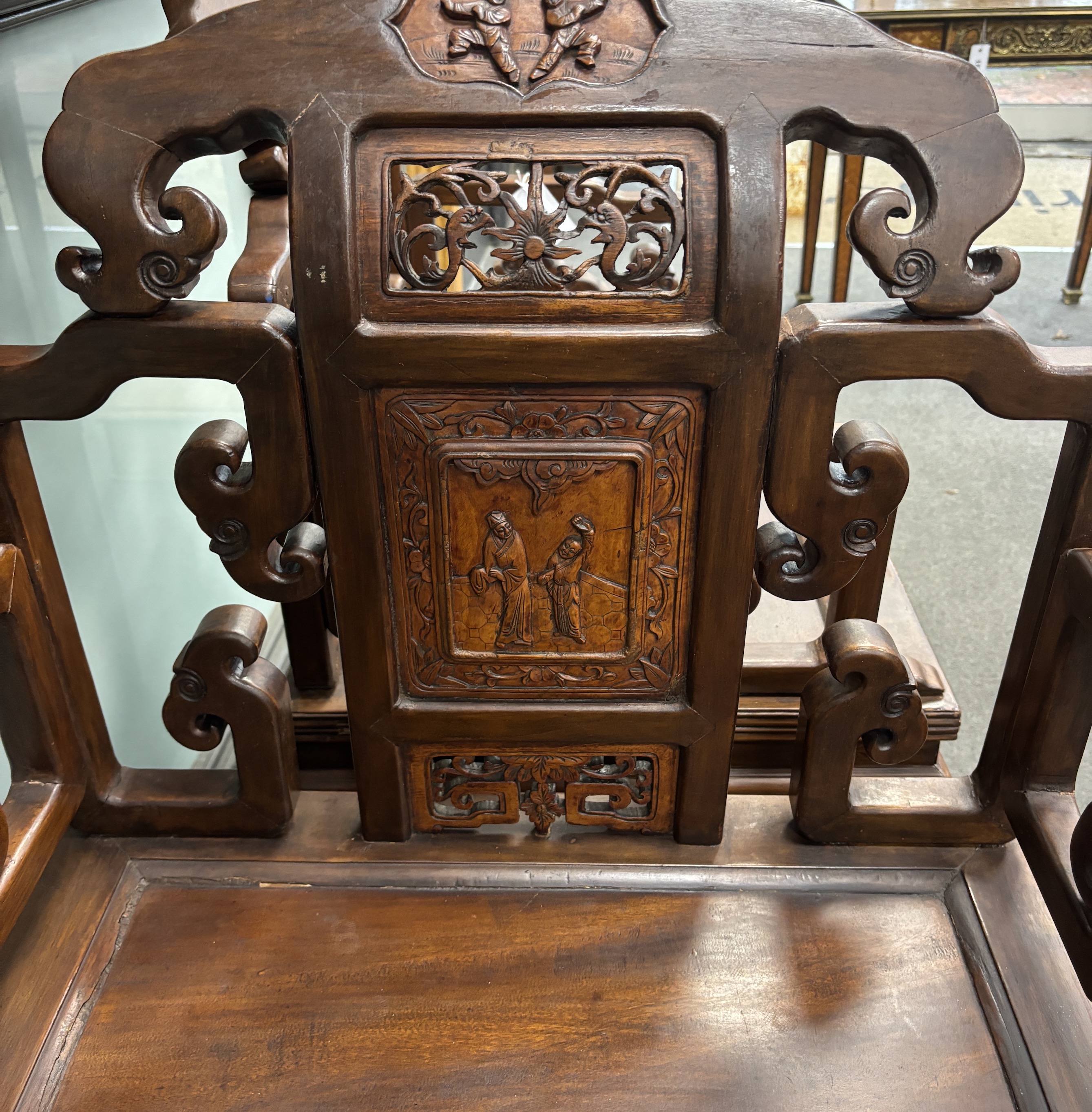A pair of Chinese carved hardwood elbow chairs, width 65cm, depth 52cm, height 103cm.